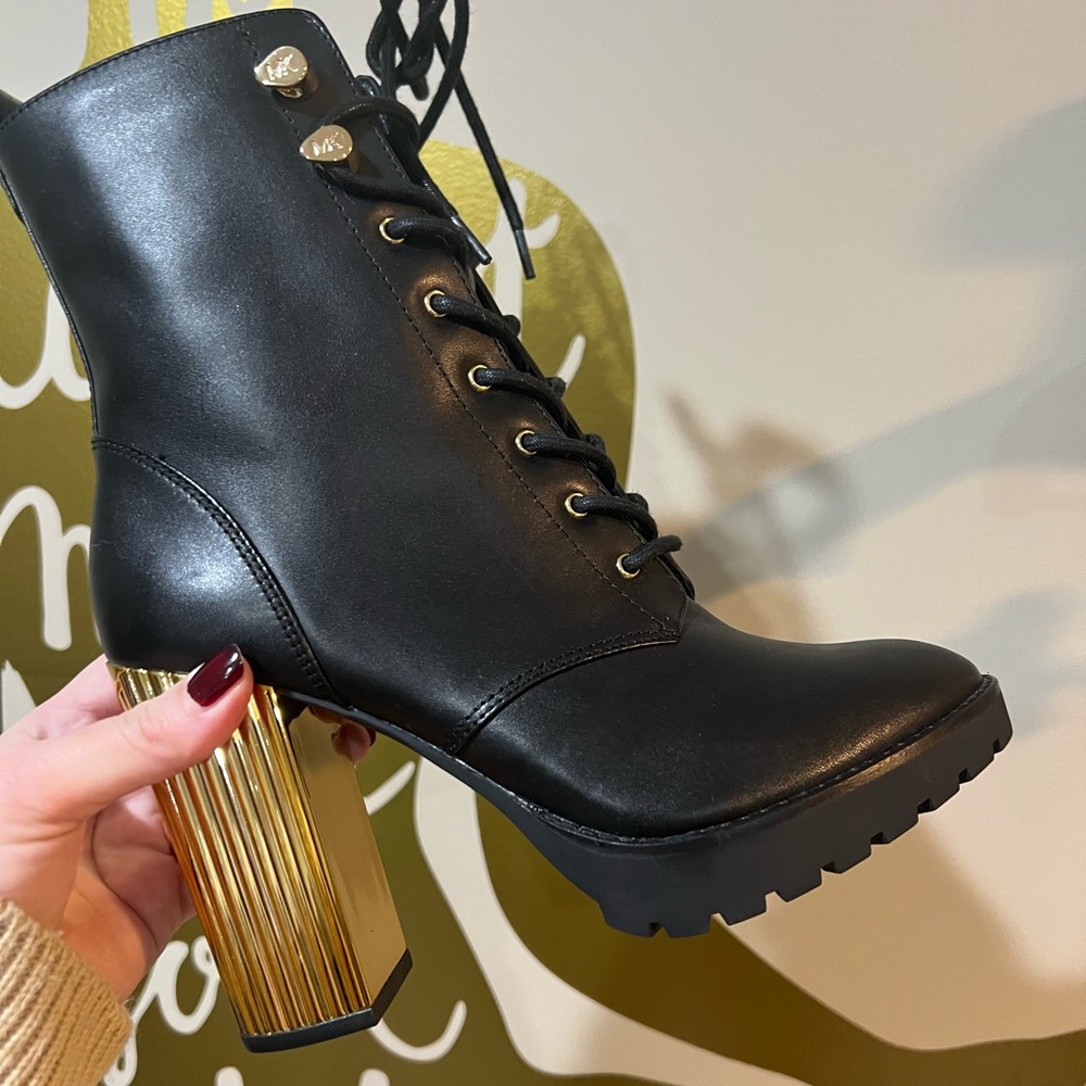 Michael Kor’s black boots with gold heel and accents.